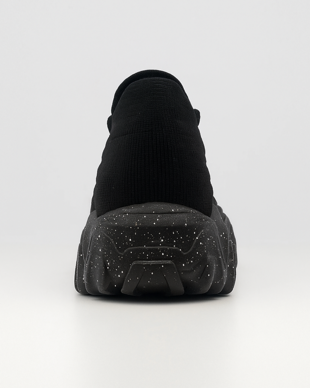Rear view of the black OrthoEase Luxe orthopedic sneaker showing heel and sole detail.