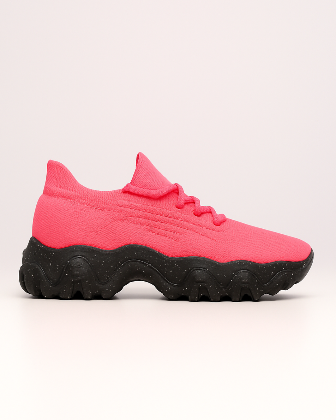 Left side of OrthoEase Luxe Voltage Pink orthopedic sneaker on beige surface